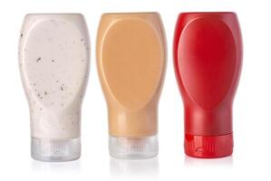 ketchup,  mustard and horseradish in bottles photo