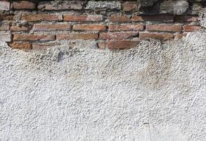 Texture of damaged brick wall photo