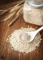 oatmeal, glass jar,white spoon photo