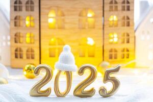 Golden figures number 2025 against the background of cozy windows of a house with warm light with festive decor of stars,snow and garlands. Greeting card, Happy New Year, cozy home photo