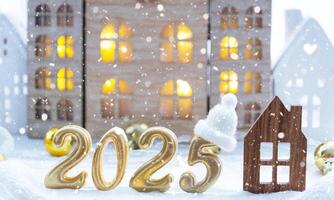 Golden figures number 2025 and tiny home on background of cozy windows of a house with warm light with festive decor of stars,snow and garlands. Greeting card, Happy New Year, cozy home photo