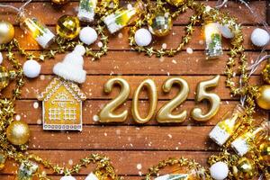 House key with tiny figure of home mock up on festive brown wooden background, lights of garlands. New Year 2025 wooden letters, greeting card. Purchase, construction, relocation, mortgage, insurance photo