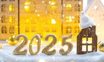 Golden figures number 2025 and tiny home on background of cozy windows of a house with warm light with festive decor of stars,snow and garlands. Greeting card, Happy New Year, cozy home photo