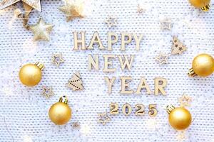Happy New Year wooden numbers 2025 on cozy festive white knitted background with sequins, stars, lights of garlands. Greetings, postcard. Calendar, cover photo