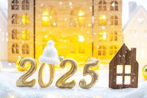 Golden figures number 2025 and tiny home on background of cozy windows of a house with warm light with festive decor of stars,snow and garlands. Greeting card, Happy New Year, cozy home photo