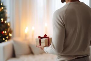 AI generated Man holding Christmas gift box at home, closeup. Festive atmosphere photo