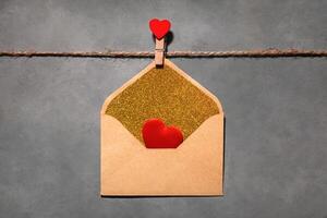 clothespins with red hearts on a rope on a gray background. Background for a postcard photo