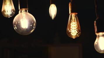 Retro light bulbs hanging on a dark background. Electricity, Vintage photo