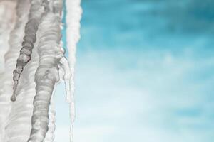 icicles on the background of the blue sky. Winter, frost photo