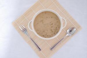 Mung Bean Porridge or Bubur Kacang Hijau, Indonesian dessert porridge of mung beans with coconut milk, pandan leaf and ginger. Served in bowl. photo