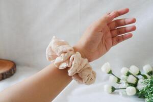 A cream scrunchie that is in the shape of a circle photo