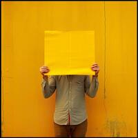 AI generated A man holding up a sheet of yellow paper. Generated by artificial intelligence. photo