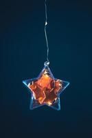 Stars made of tangerine peel in a Christmas tree toy and garlands photo