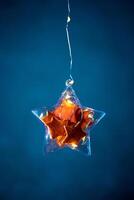 Stars made of tangerine peel in a Christmas tree toy and garlands photo