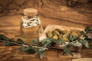 olive fruits oil on olive wood photo