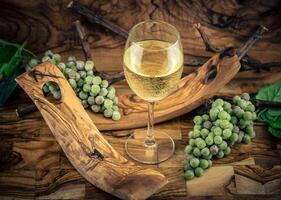 white wine grapes on olive wood photo
