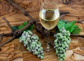 white wine grapes on olive wood photo