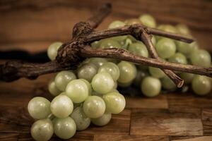 white wine grapes on olive wood photo