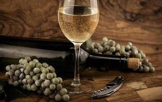 white wine grapes on olive wood photo