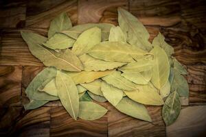 Bay leaves and on olive wood photo
