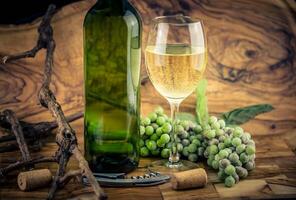 white wine grapes on olive wood photo