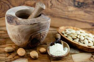 fresh blanched almond on olive wood photo