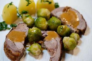 Roast turkey with Brussels sprouts potatoes and gravy photo