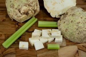 Fresh celery Apium graveolens on olive wood photo