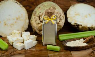 Fresh celery Apium graveolens on olive wood photo