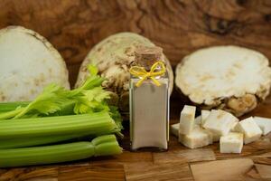 Fresh celery Apium graveolens on olive wood photo