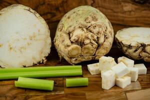 Fresh celery Apium graveolens on olive wood photo