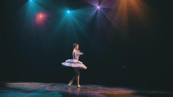 Ballet. Graceful ballerina dancing elements of classical ballet in the beautiful light and smoke on the background, High quality video