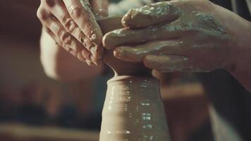 the hands of a potter making a jug of clay video