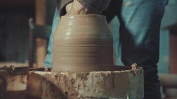 the hands of a potter making a jug of clay video