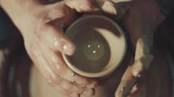 the hands of a potter making a jug of clay video