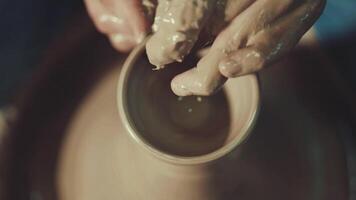 the hands of a potter making a jug of clay video