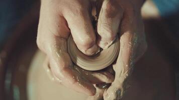 the hands of a potter making a clay jug video