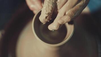 the hands of a potter making a jug of clay video