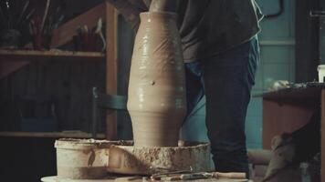 the hands of a potter making a jug of clay video