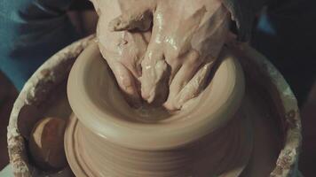 the hands of a potter making a jug of clay video