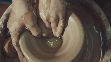 the hands of a potter making a clay jug video