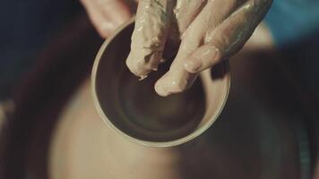 the hands of a potter making a jug of clay video