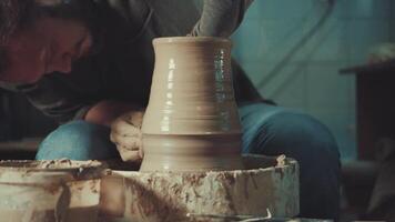 the hands of a potter making a jug of clay video