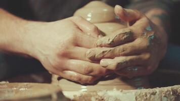 the hands of a potter making a jug of clay video