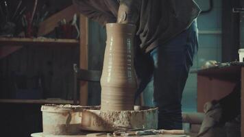 the hands of a potter making a jug of clay video