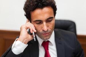 Portrait of a businessman talking on the phone photo