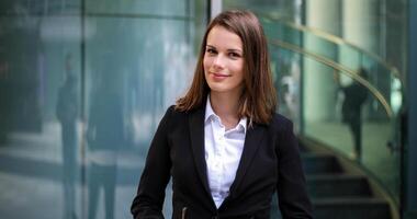 Confident young female manager outdoor in a modern urban setting photo