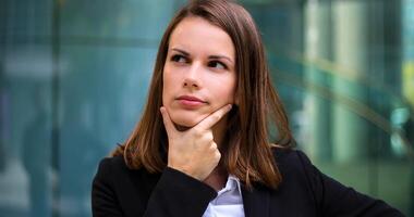 Smiling businesswoman poirtrait in a pensive expression photo