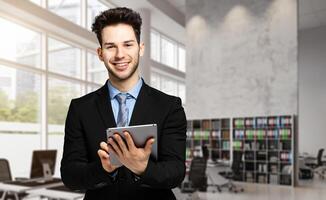 Young manager using a digital tablet in his office photo