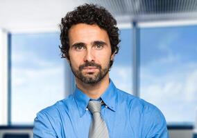 Portrait of a handsome businessman in a modern office photo